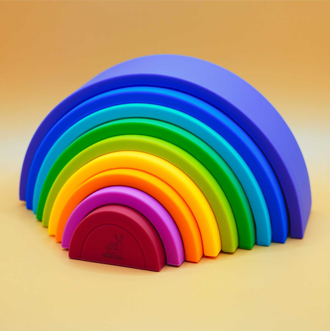 pieces spread apart of rainbow stacking toy puzzle